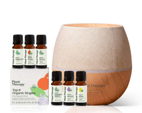 Plant Therapy essential oil bottles displayed beside a diffuser